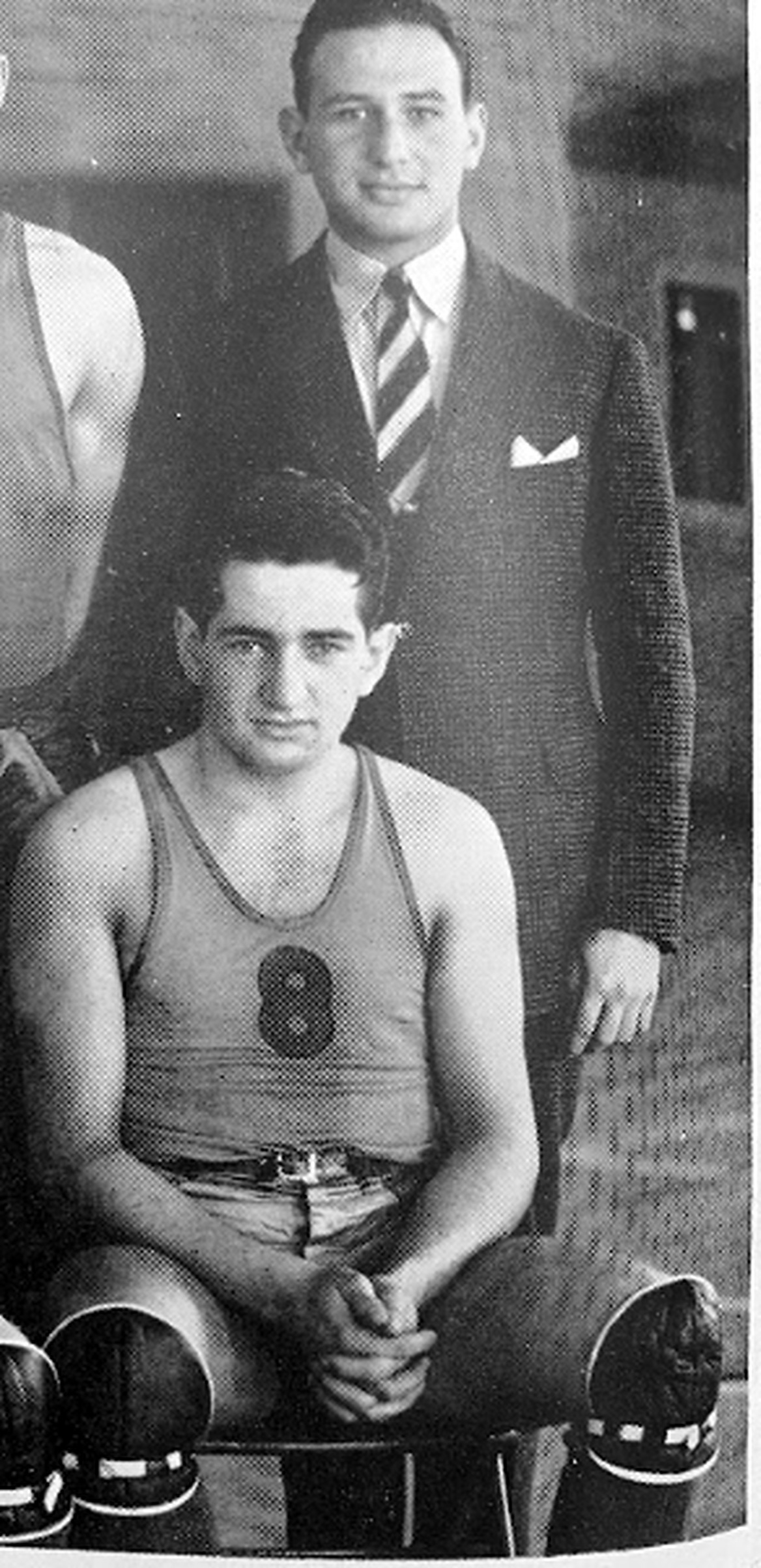 Ben Newman in his Queen's basketball uniform with his brother and coach
